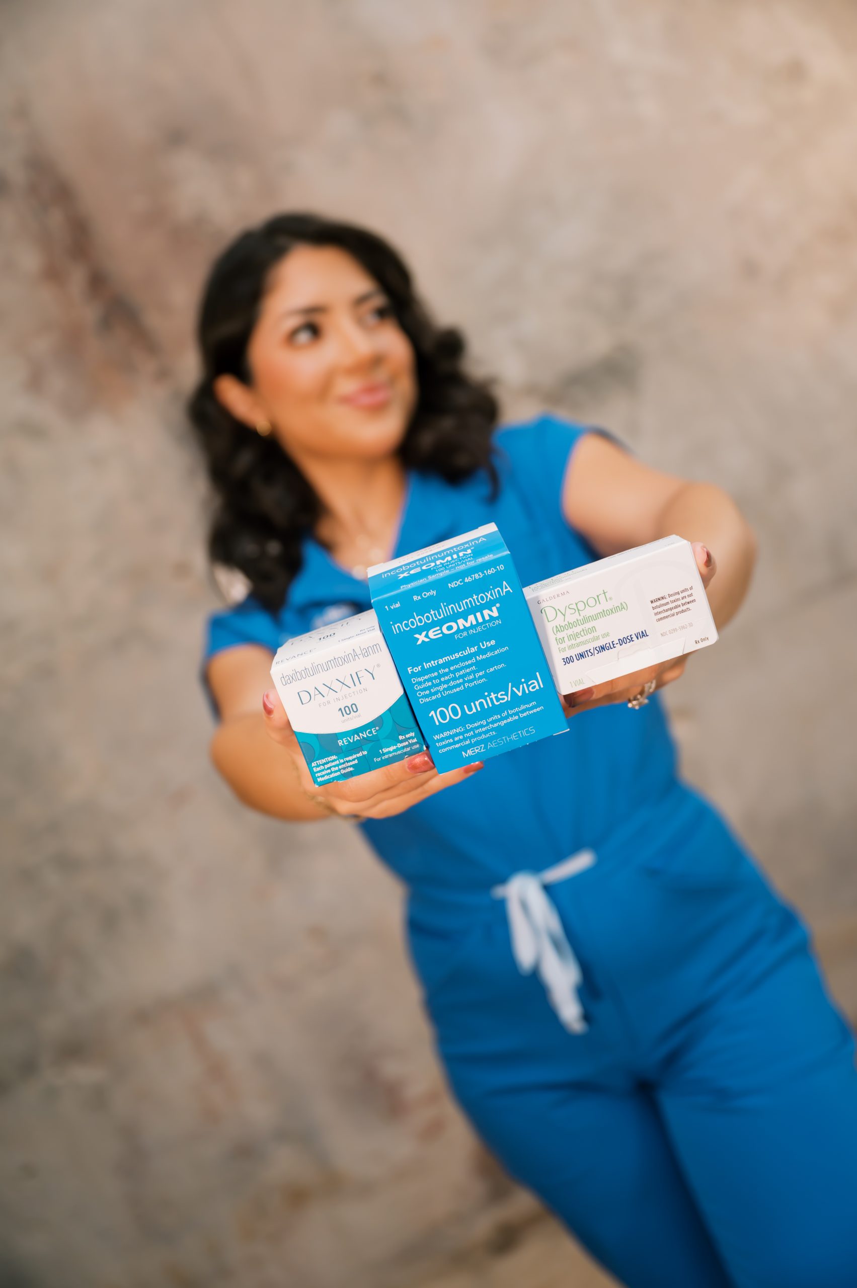 Daisy RN holding Daxxify Xeomin and Dysport neurotoxin products at 88 Wellness & Aesthetics in Burleson TX